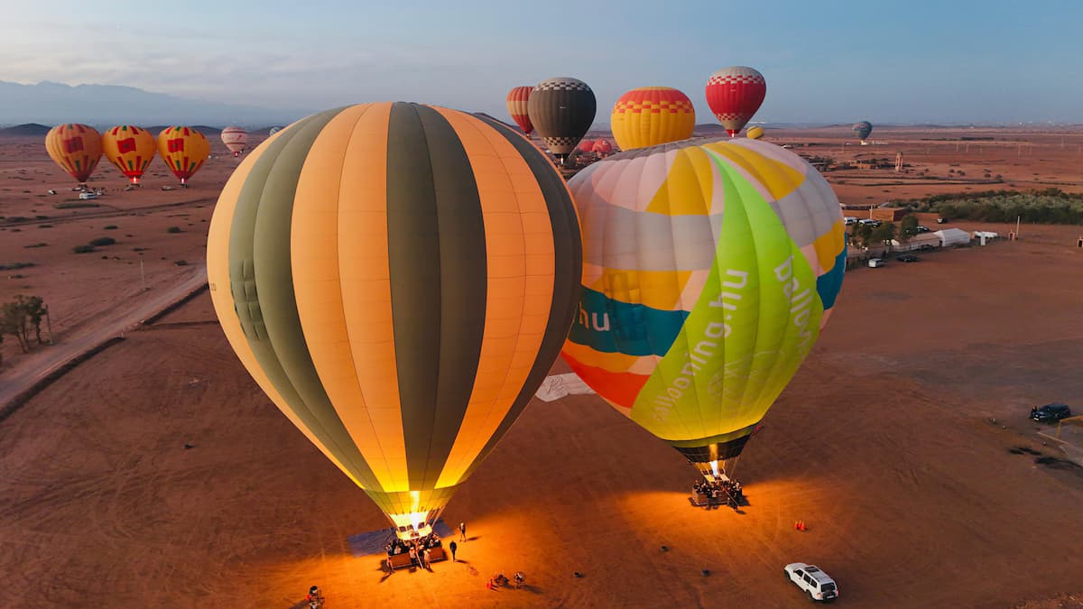 Two balloons glowing as their burners fire at first light